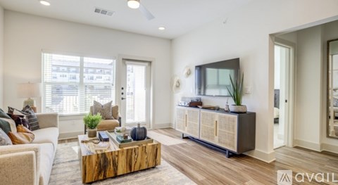 A living room with a wooden coffee table and a large flat screen TV.