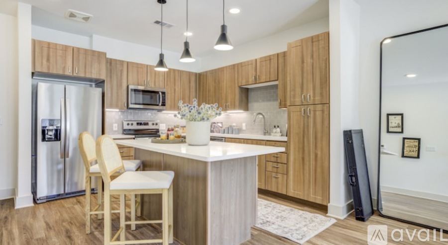 A kitchen with wooden cabinets and a white island.