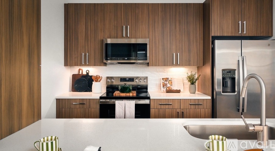 A modern kitchen with wooden cabinets and stainless steel appliances.
