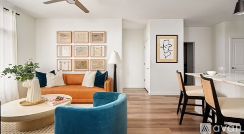 A living room with a blue chair and a white table.