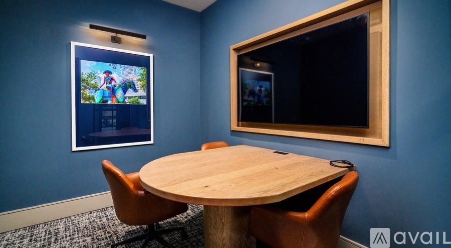 A conference room with a round table and chairs.