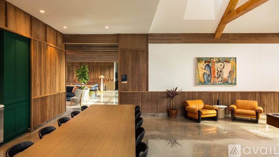 A conference room with a long table and chairs.