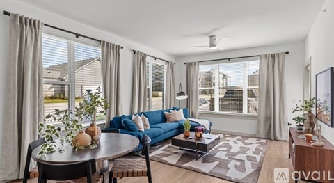 A living room with a blue couch and a coffee table.
