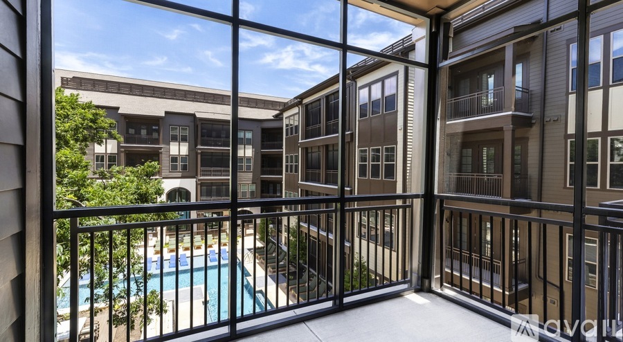 A balcony with a pool and a view of a building.
