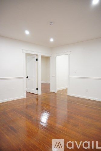 A room with wooden floors and white walls.