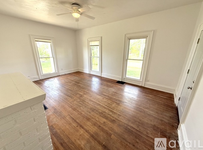 A room with wooden floors and white walls.