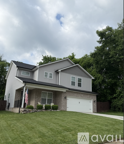 A house with a grey roof and a white garage door.
