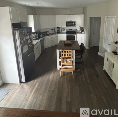 A kitchen with a table and chairs in the middle of the room.