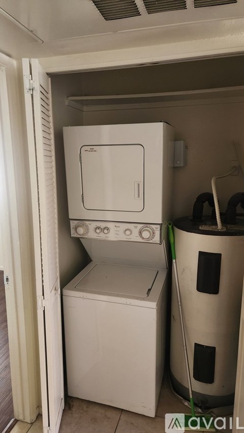 A white dishwasher is in a small kitchen.