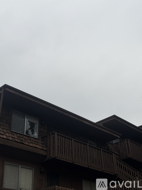 A building with a balcony and a window with a broken pane.
