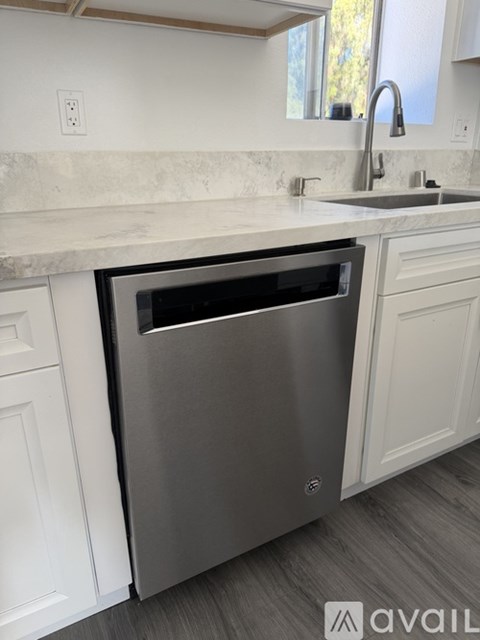 A dishwasher is built into a kitchen counter.