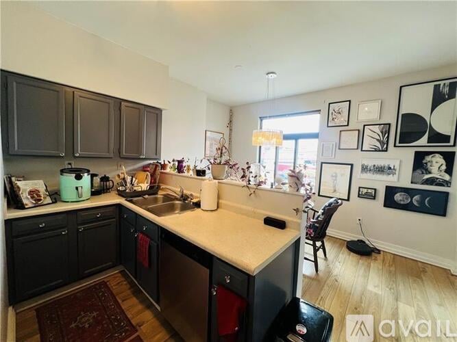 A kitchen with black cabinets and a white countertop.