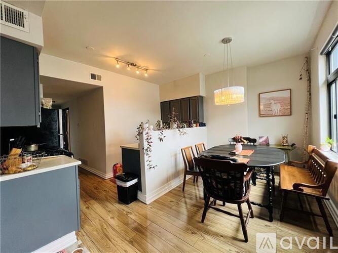 A dining room with a table set for six with chairs around it.