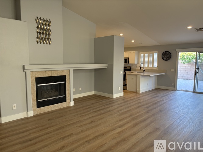 A modern living room with a fireplace and wooden floors.