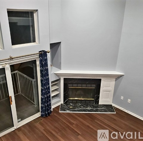 A living room with a fireplace and a sliding glass door.