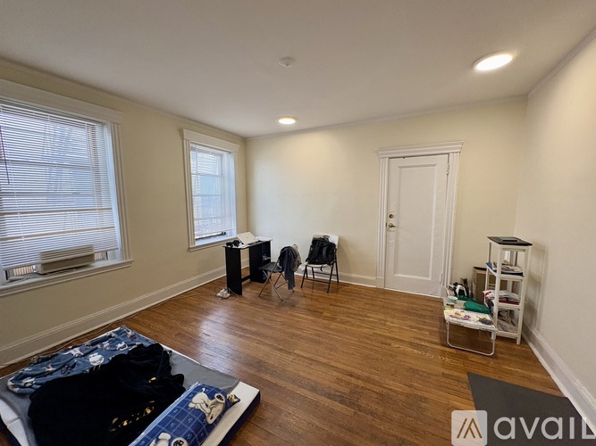 A room with a bed, chair, and desk.