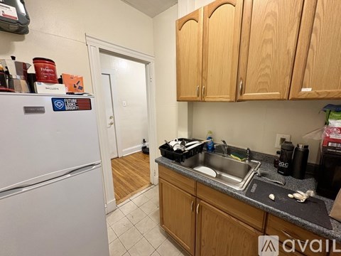 A kitchen with wooden cabinets and a white refrigerator.
