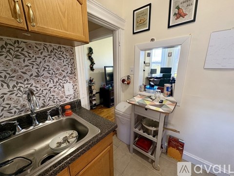 A kitchen with a sink and a dish rack.