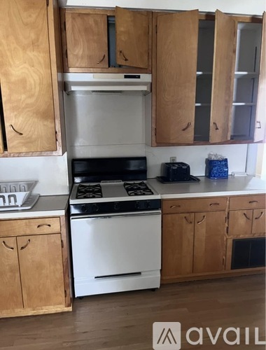 A kitchen with wooden cabinets and a white oven.