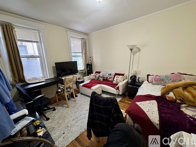 A bedroom with a bed, desk, and chair.