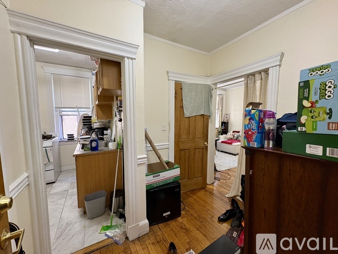 A room with a lot of boxes and items scattered about.