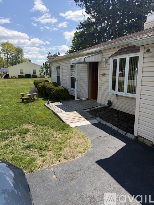 A house numbered 105 with a small front yard.