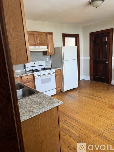 A kitchen with a white fridge and a stove top oven.