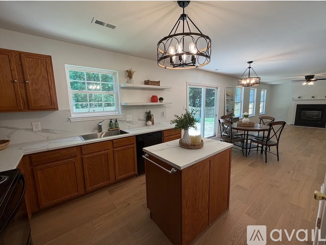 A kitchen with wooden cabinets and a white countertop.