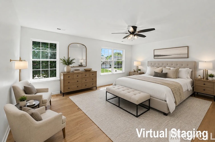 A bedroom with a large bed, a chair, a dresser, and a window.