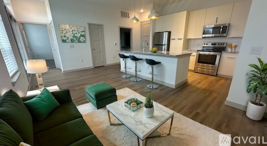 A living room with a green couch and a coffee table in the foreground.