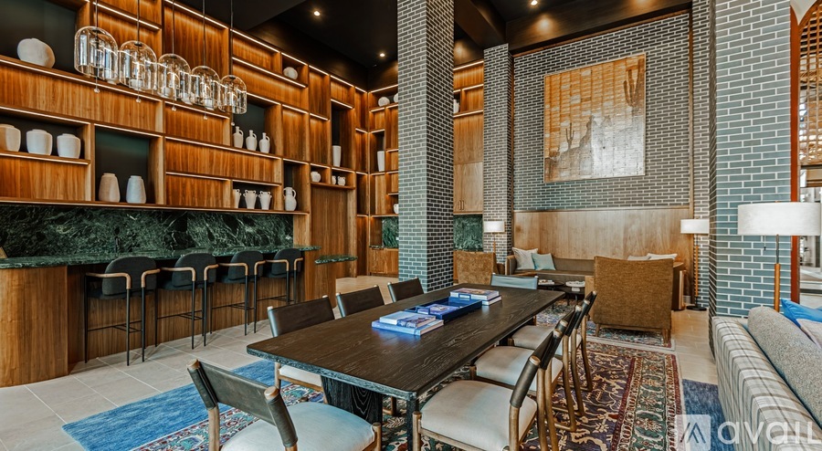 A modern dining area with a long table and chairs.