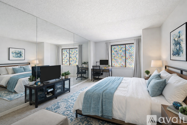 A bedroom with a large bed and a television.