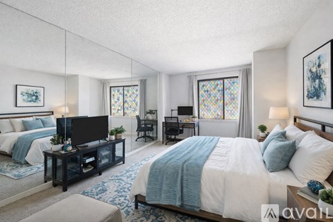 A bedroom with a large bed and a television.