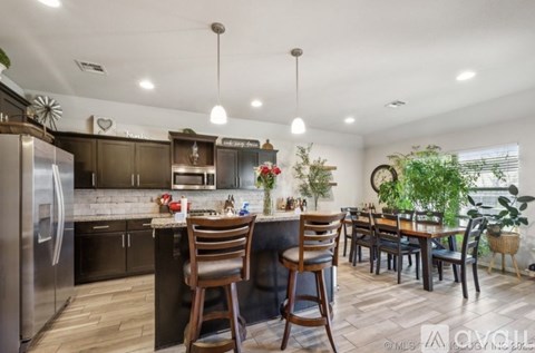 A modern kitchen with a dining table and chairs.
