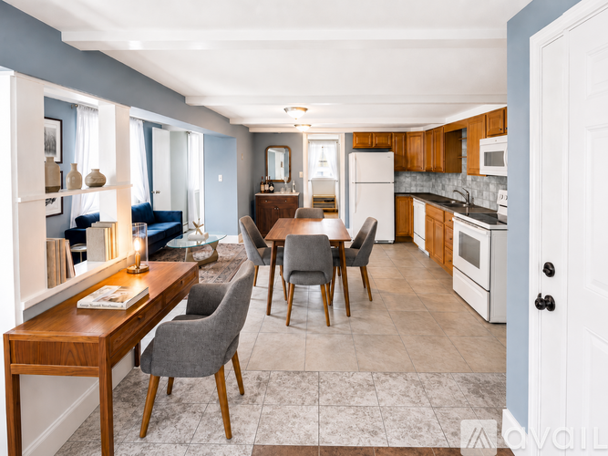A kitchen with a table and chairs in the middle of the room.