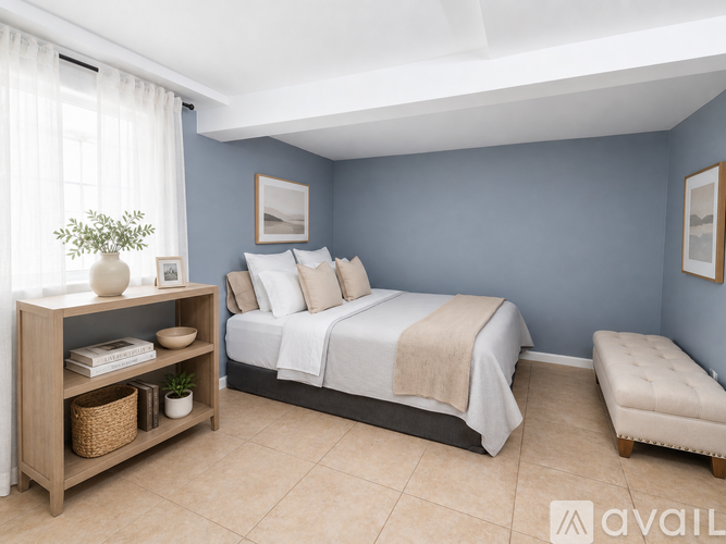 A bedroom with a bed, nightstand, and a shelf with decorative items.