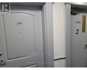 A white door with the number 205 on it.