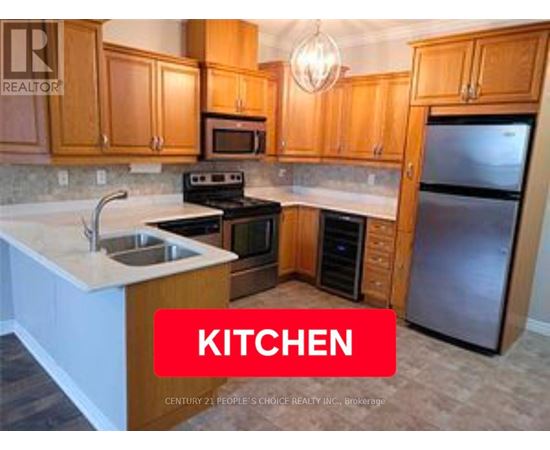 A kitchen with wooden cabinets and a stainless steel refrigerator.