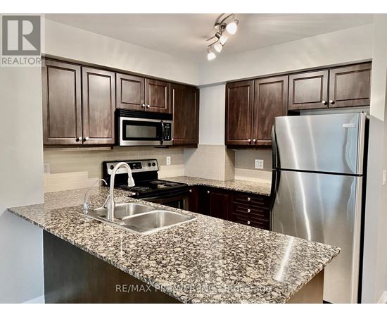 A kitchen with granite countertops and stainless steel appliances.