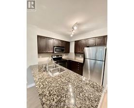 A kitchen with granite countertops and stainless steel appliances.