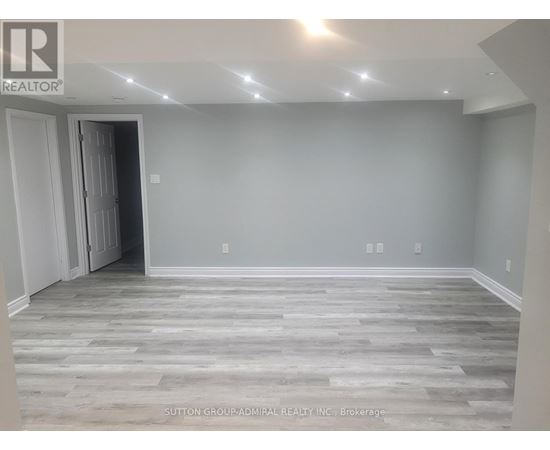 A room with grey walls and wooden flooring.