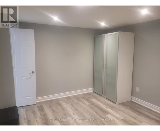 A room with a white door and a glass wardrobe.