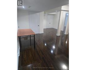 A room with wooden floors and white walls.