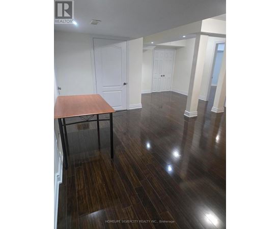 A room with wooden floors and white walls.