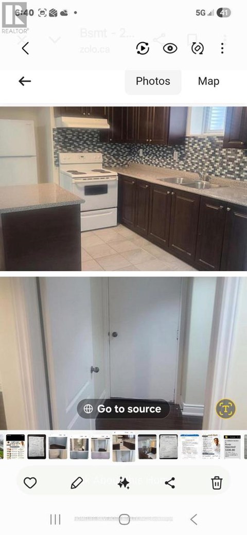 A kitchen with dark brown cabinets and a white stove top oven.