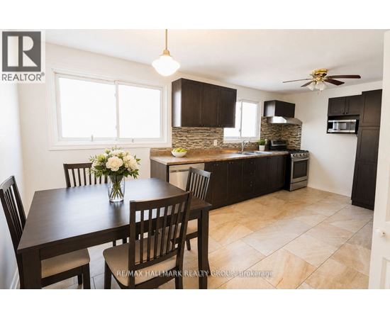 A dining room with a table set for four.