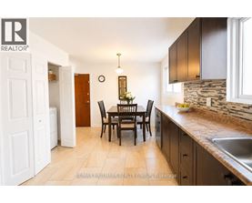 A kitchen with a table and chairs in the middle of the room.