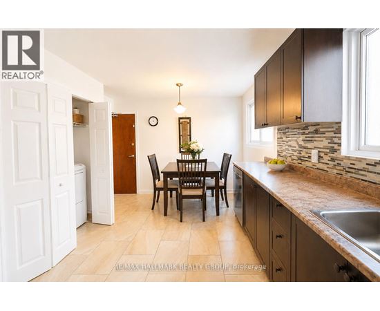 A kitchen with a table and chairs in the middle of the room.