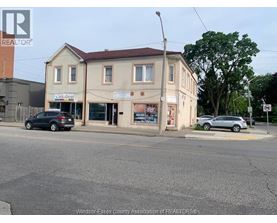 A street view with a building that has a sign that says "link shop".