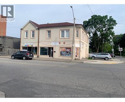A street view with a building that has a sign that says "link shop".